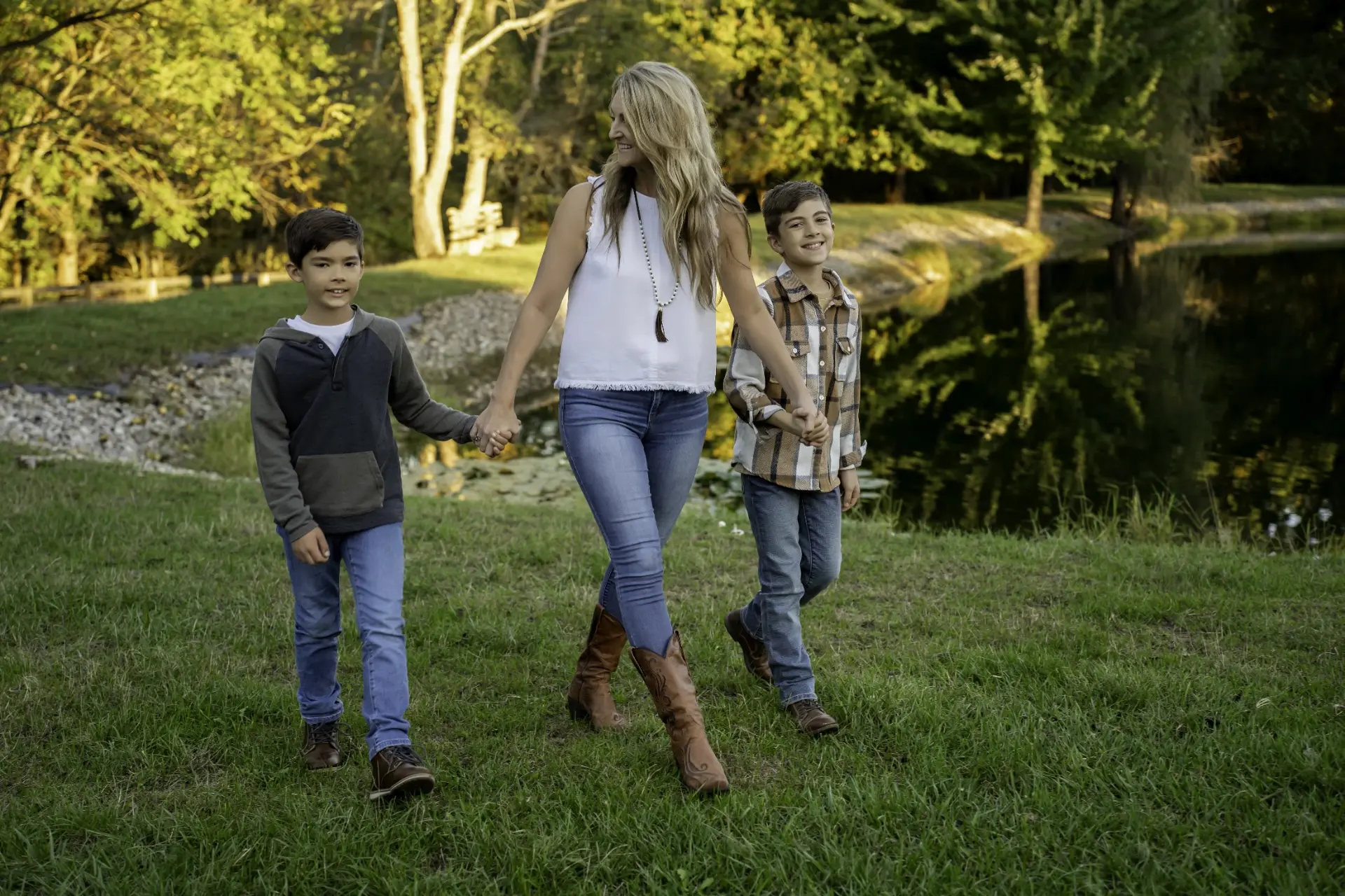 Holly Marie Thomson walking with her two sons beside a pond in Central Ohio